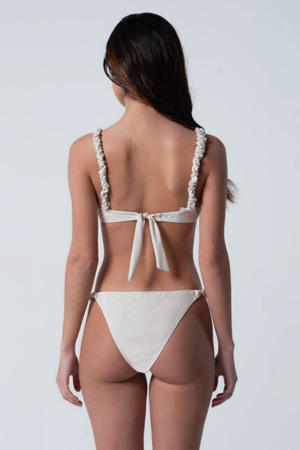 Ruched elastic shoulder straps No clasp Elastic waistband Brazilian cut Fully lined Removable light pads Model is wearing a size S